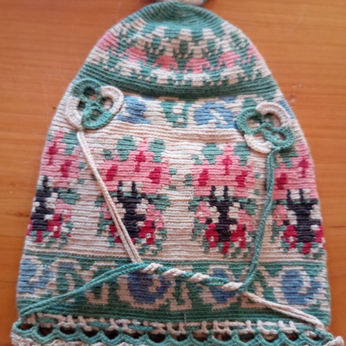 Handmade traditional embroidered or knitted pouch hat with folk motifs