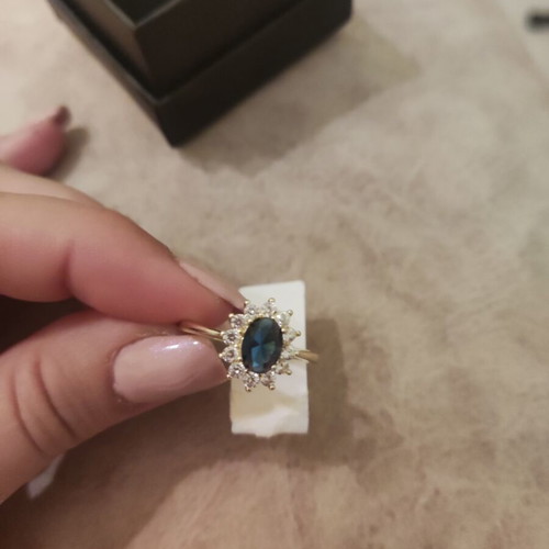 Women's rosetta ring new, gold color with blue oval stone and zircons