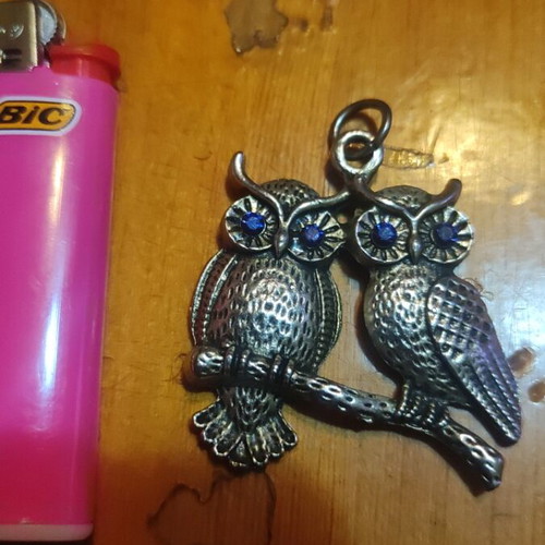 Silver pendant with two owls and dark blue stones