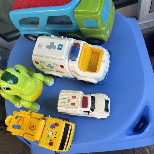 Various toys including vehicles and dinosaur