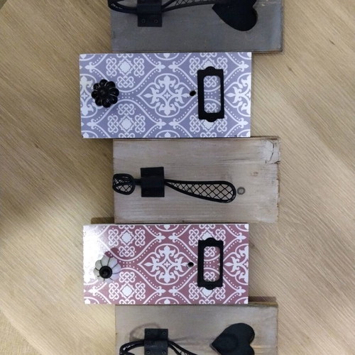 Decorative wall hanger used with wooden base and metal hooks
