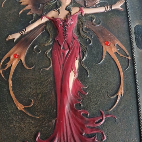 Iron notebook like new with embossed designs and magnet