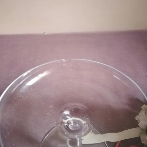 Glass candlestick with wreath and two-tone candle used