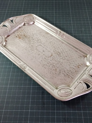 Art Deco metal serving tray used with embossed designs
