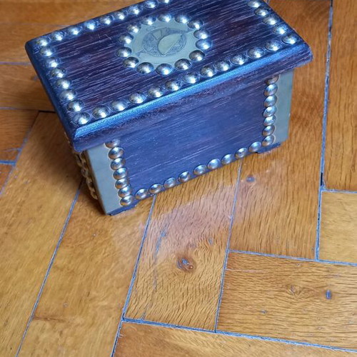 Decorative small wooden chest used with metal details