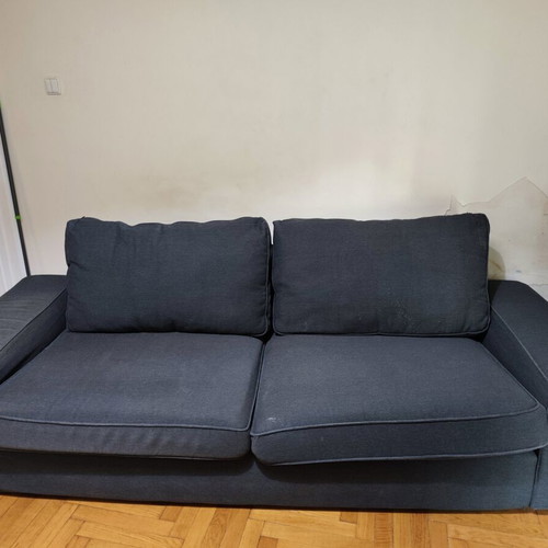 Two-seater fabric sofa used, dark gray color with visible marks