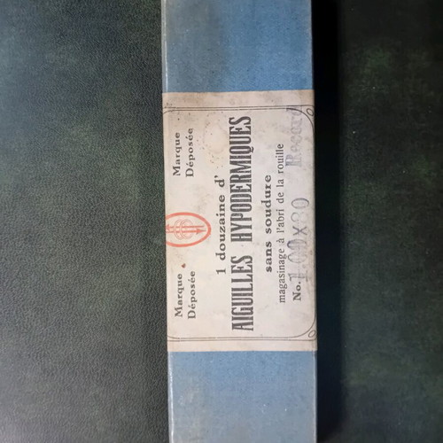 Antique glass syringe used with needle box