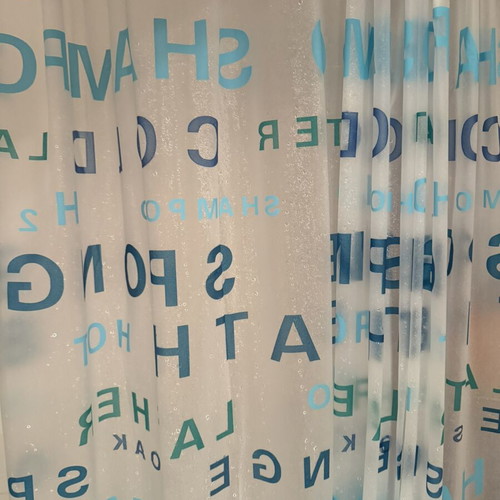 Shower curtain with blue letters