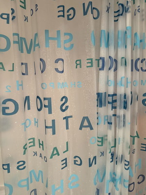 Shower curtain with blue letters