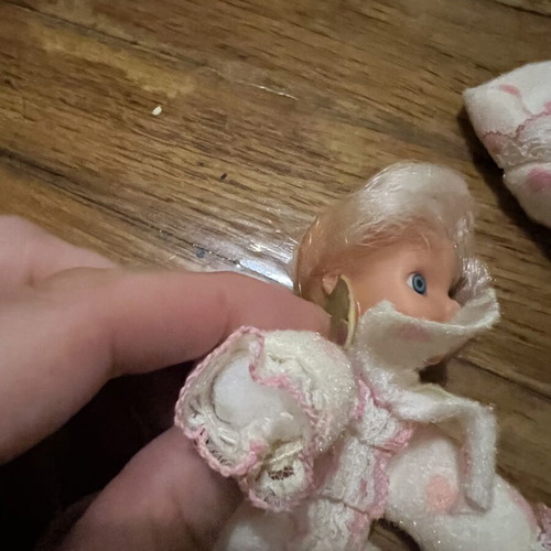 Doll with hood, missing one leg and one arm, slight tear