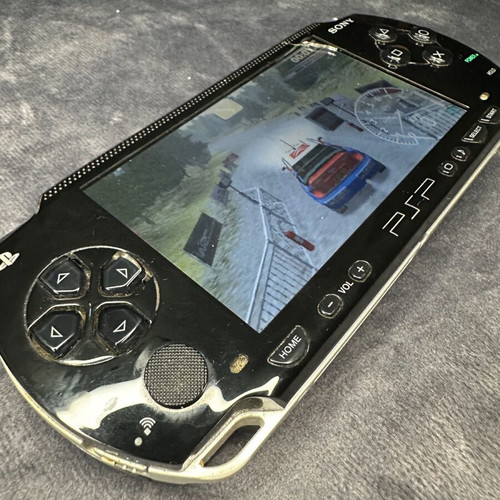 PlayStation Portable PSP-1000 used with charger, 5 games, and Memory Stick