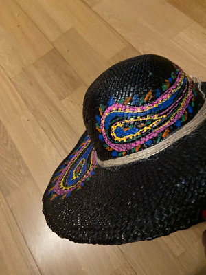 Painted hat on black background new for distinctive ladies