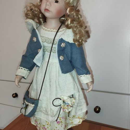 Porcelain doll rare, new with hat and dress