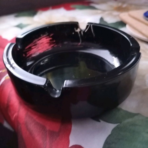 Glass ashtray vintage black classic with four cigarette slots used