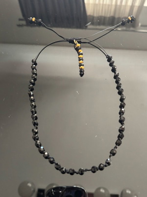 Necklace new with sparkling stones in black and gold