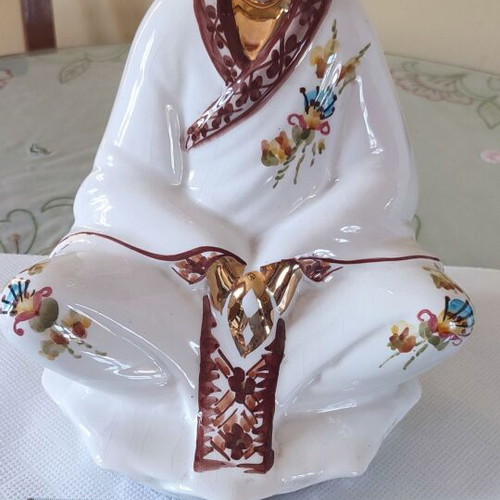 Vintage porcelain Buddha statue with gold details
