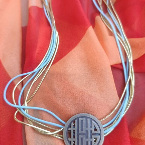 Metal necklace with turquoise and gold elastic cords