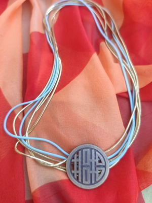 Metal necklace with turquoise and gold elastic cords