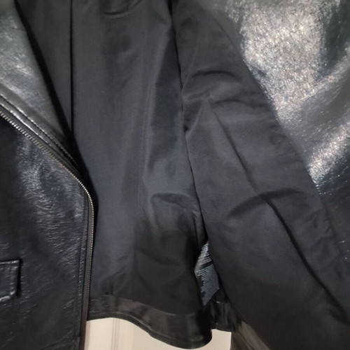 Only black biker jacket made of faux leather with silver details used