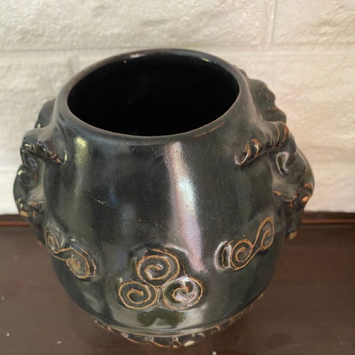 Black ceramic vase with ram’s head decoration