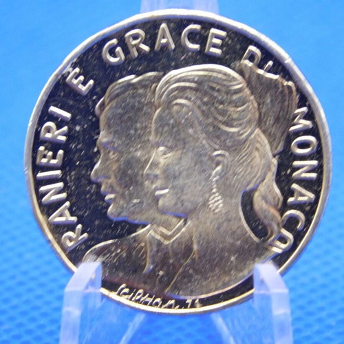 Commemorative metal token with Prince Rainier and Grace Kelly of Monaco