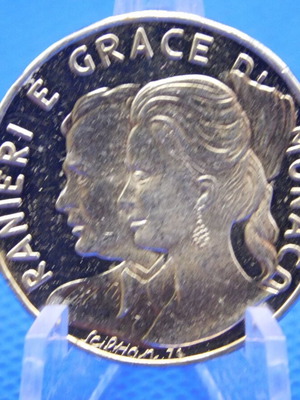 Commemorative metal token with Prince Rainier and Grace Kelly of Monaco
