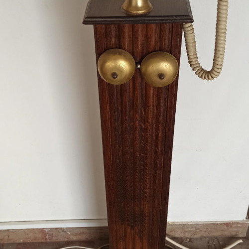 Antique hotel telephone used, wooden column with brass supports