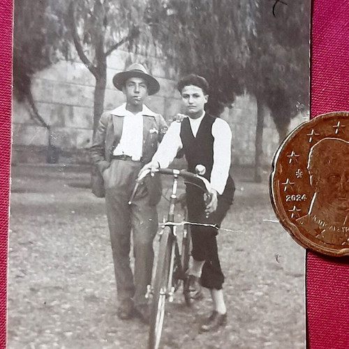 Vintage black and white photo with young men and bicycle, used
