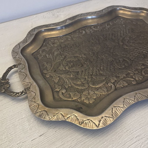 Vintage metal serving tray used with embossed floral and geometric carvings