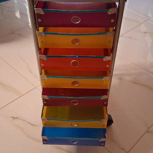 Modern wheeled drawer unit used with seven colorful plastic drawers