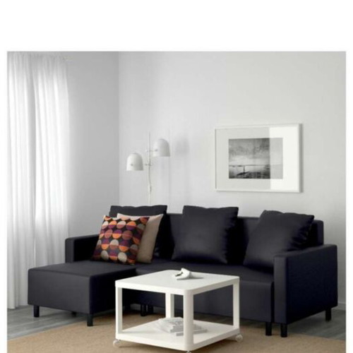 Lugnvik IKEA corner sofa bed used with storage and coffee table