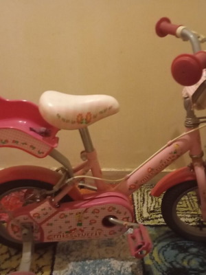 Children's pink bike with training wheels used