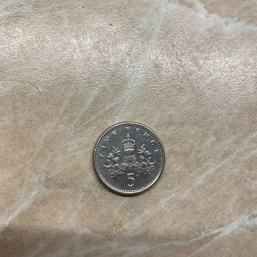 Coins one penny 2010 and five pence 1991 used
