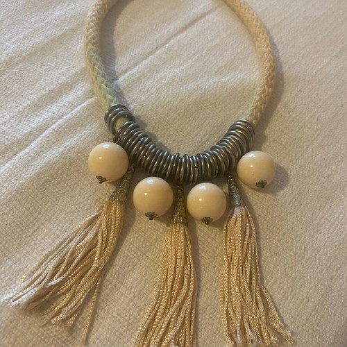 Necklace used with soft cord, metal elements and beige beads