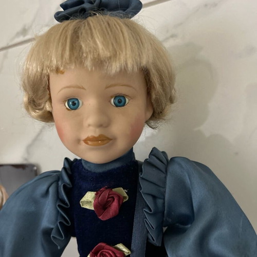 Porcelain doll like new vintage with blue satin dress