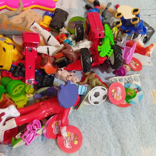 Box of various used children's toys including pop-it and wooden drum