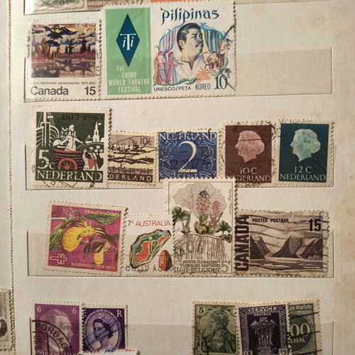 Stamp album like new with about 500 mostly foreign stamps