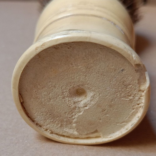 Two shaving brushes, one says it is made in West Germany.