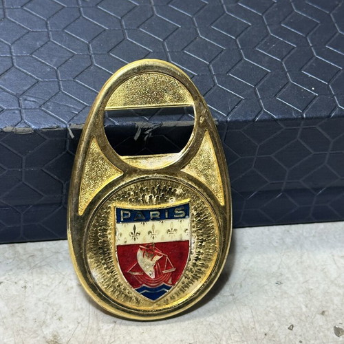 Vintage metal bottle opener Paris with embossed city crest, used