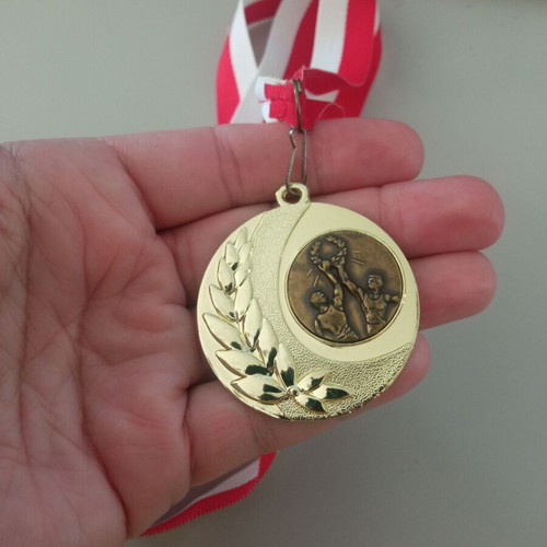 Gold victory medal new with red and white ribbon