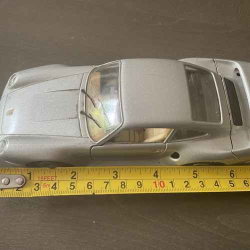 Burago metal toy car Porsche 959 M1:24 used with missing headlight and cracked glass