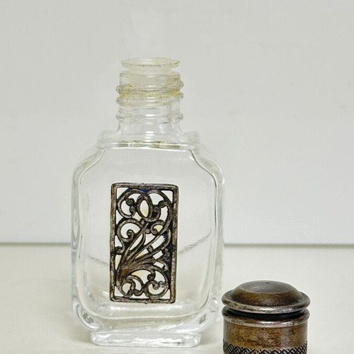 Vintage glass perfume bottle with metal decoration