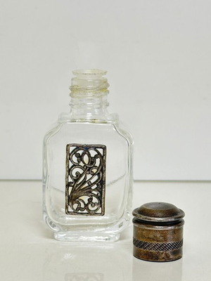 Vintage glass perfume bottle with metal decoration