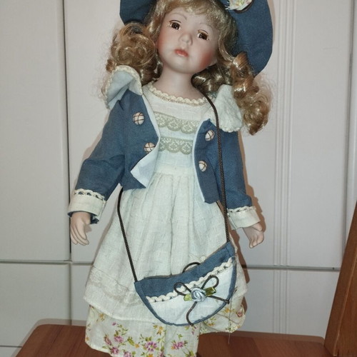 Porcelain doll rare, new with hat and dress