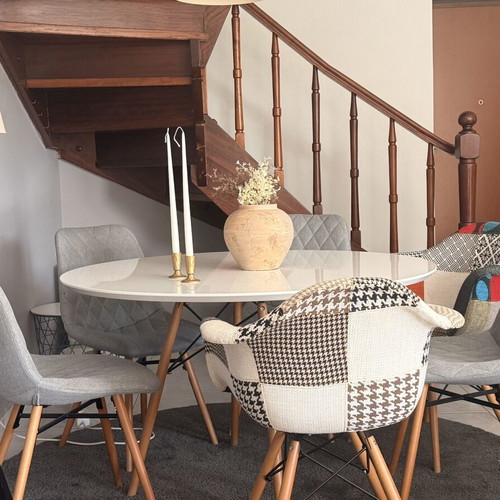 Modern dining set with round white lacquer table and fabric chairs used