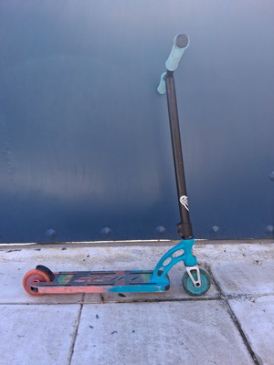 Mad Gear Pro stunt scooter used with original two-tone wheels