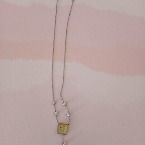Silver necklace used with white stones and yellowish square