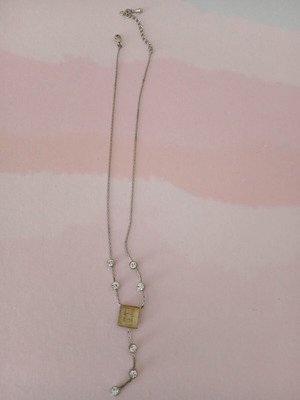 Silver necklace used with white stones and yellowish square