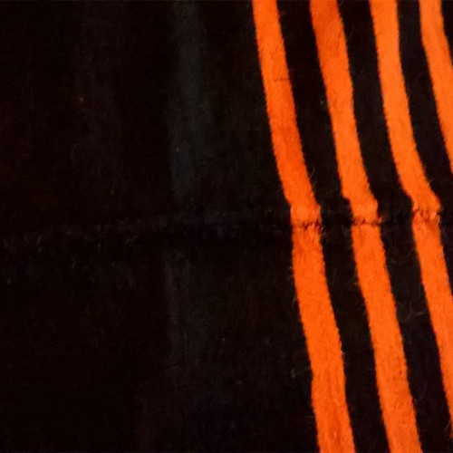 Woven blanket used orange and blue in two joined pieces
