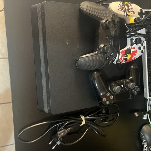 Sony PlayStation 4 Slim console used with 3 controllers and cables